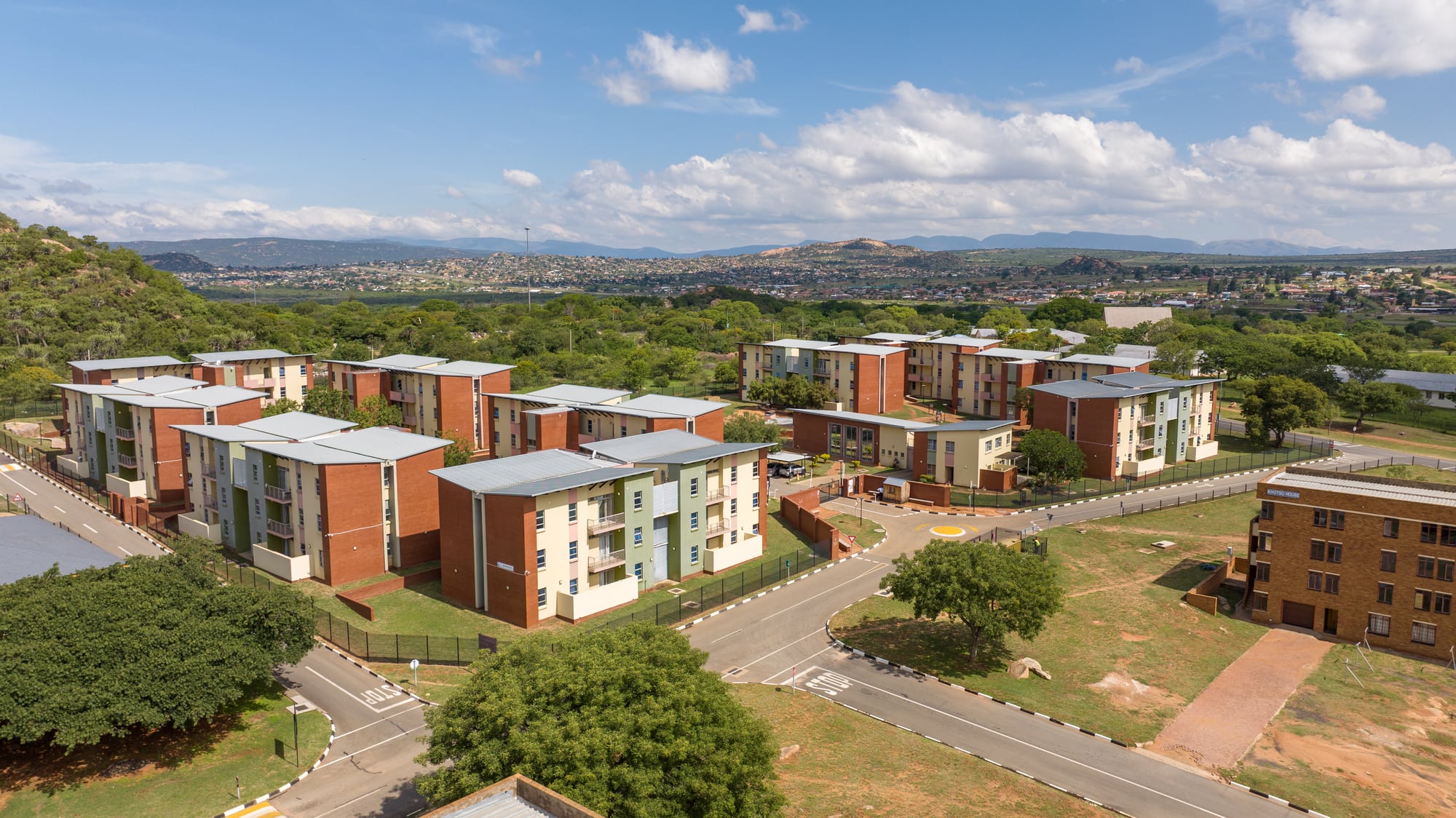 Side view of the residential blocks set within the landscaped, mountain-edge site